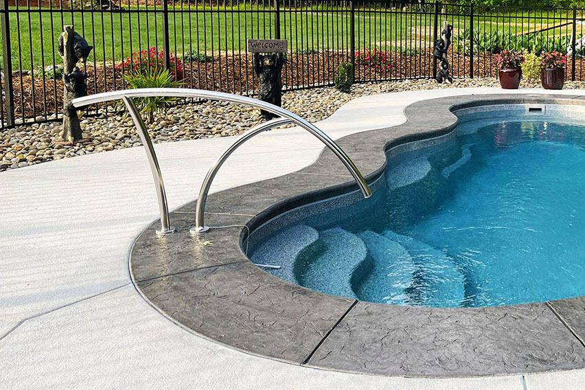 in-ground fiberglass pool with modern handrail